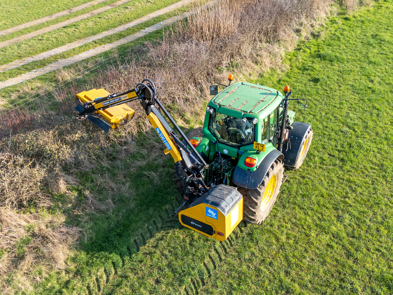 McConnel PA6567T mounted on a john deere tractor cutting a hedge 